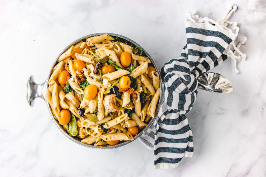 Mediterranean Pasta in a unique metal pot with a blue and white strip napkin tied around the handle