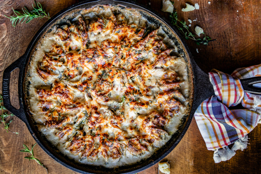 vegetable au gratin with cheese sauce in cast iron skillet