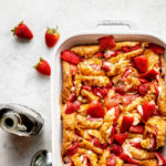 Strawberry croissant breakfast casserole in a white baking dish