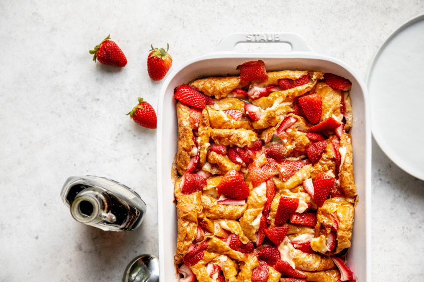 Strawberry croissant breakfast casserole in a white baking dish