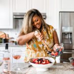 watermelon salad with berries and roasted beets, black woman making a salad in an Anthropologie dress