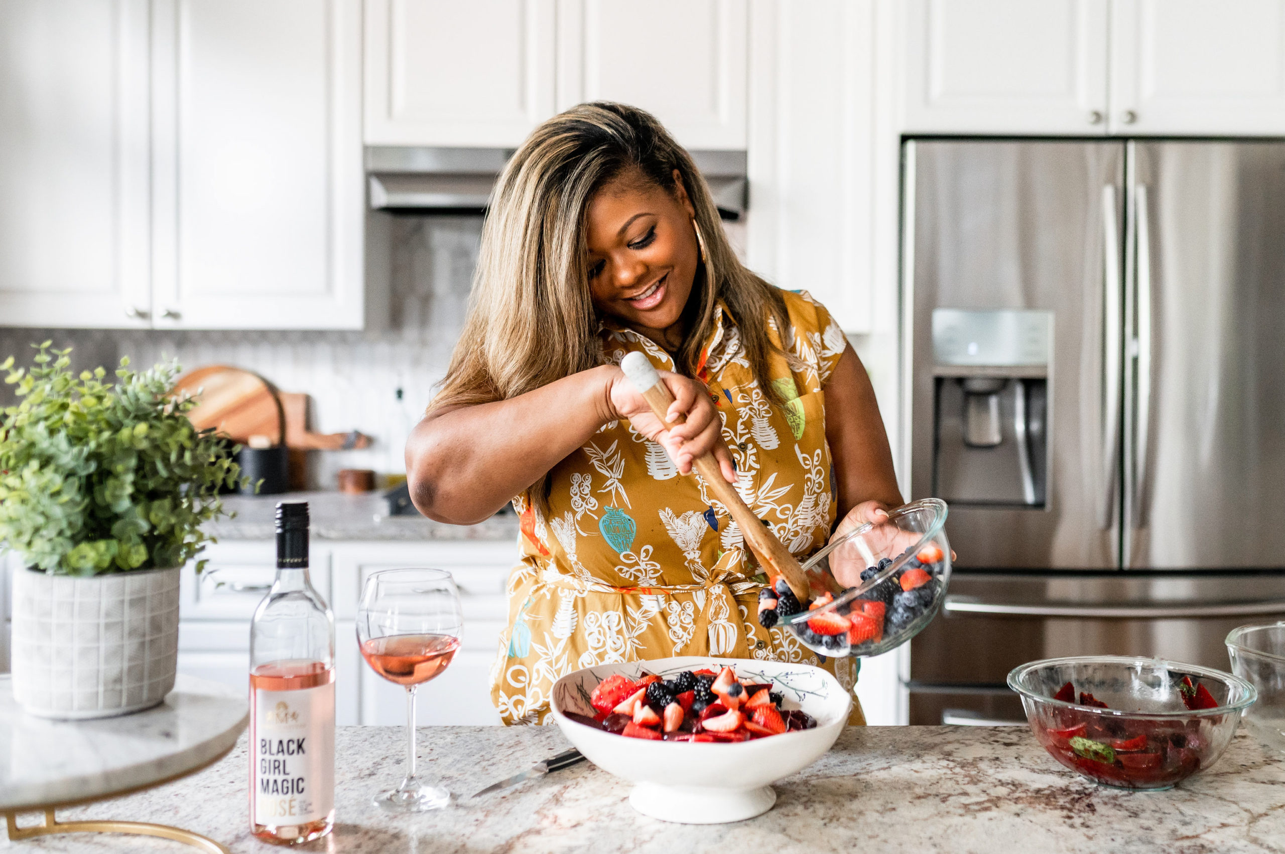 watermelon salad with berries and roasted beets, black woman making a salad in an Anthropologie dress